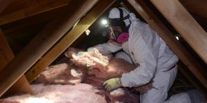 BPI Certified Professional adding batts of insulation to an attic